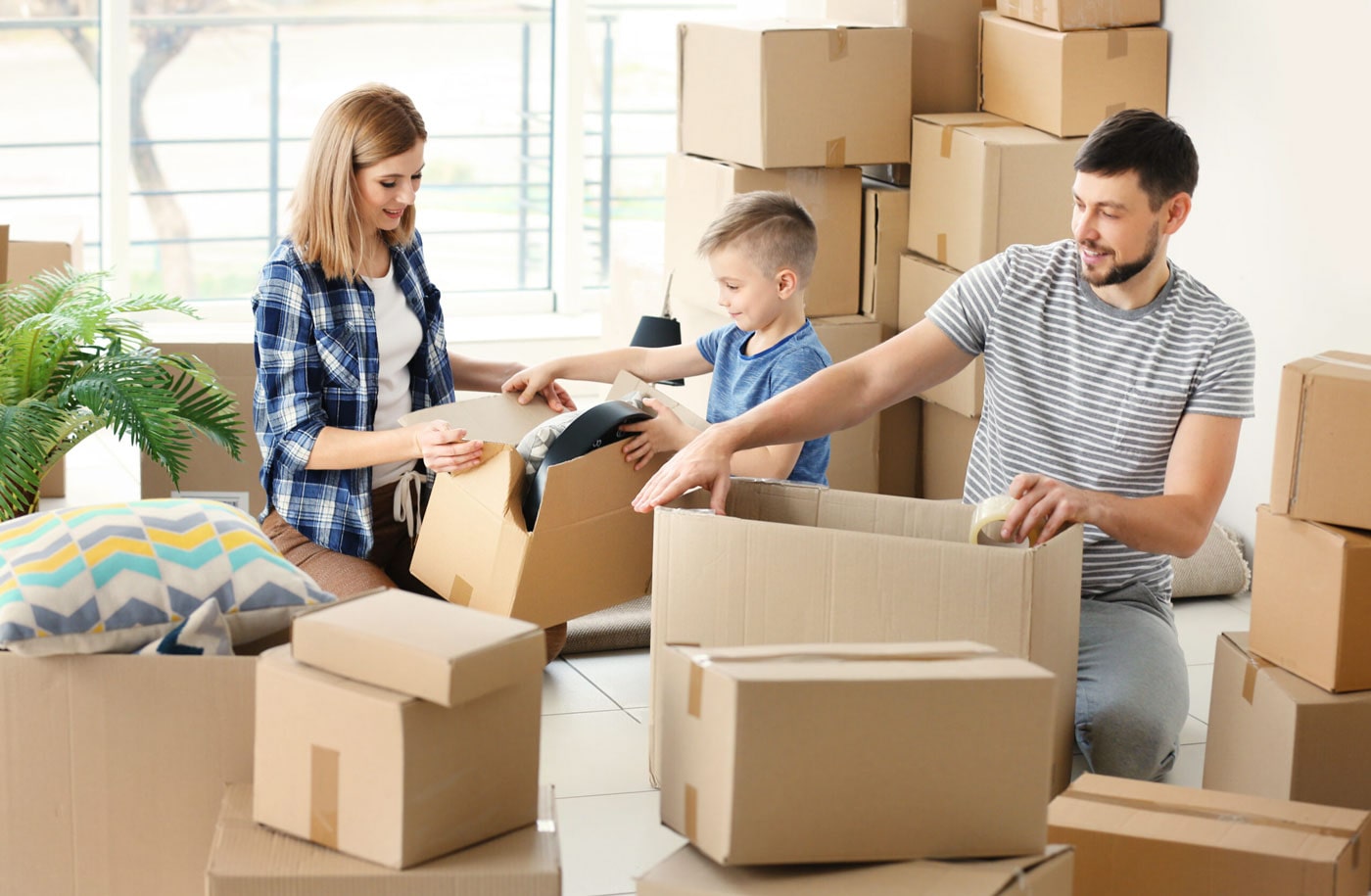 Smiling family unpacking boxes