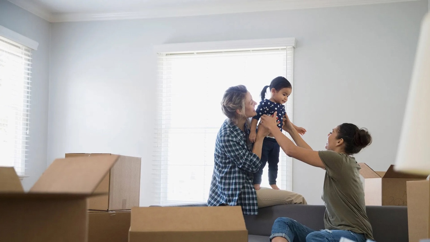 Happy family in new home with unpacked boxes