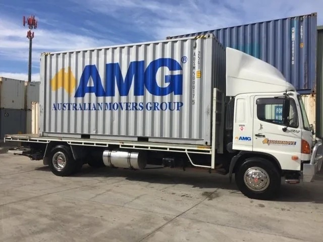 Shipping container loaded on to a removalist truck