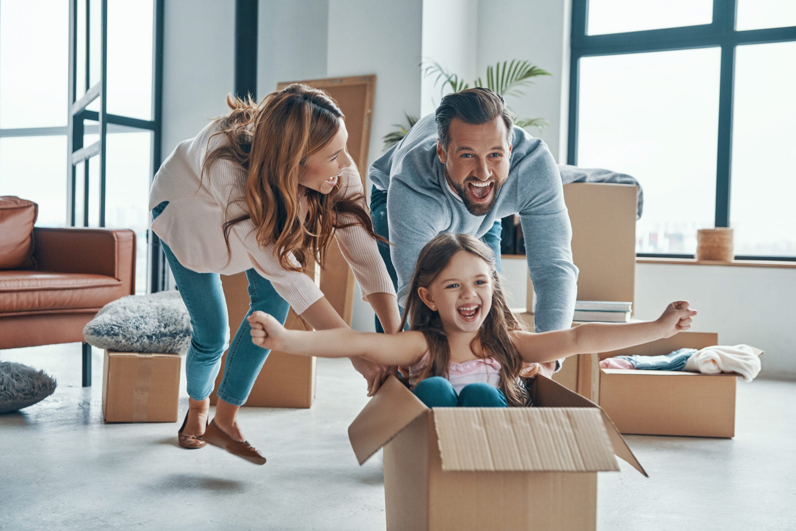 family unboxing their stuff while moving into a new apartment